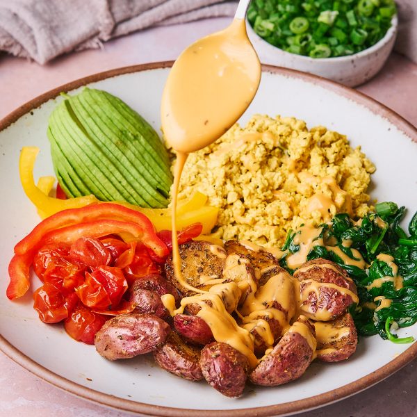 Hearty vegan breakfast bowl, complete with a Dairy-Free Cheddar Sauce using Follow Your Heart Dairy-Free Cheddar Shreds!